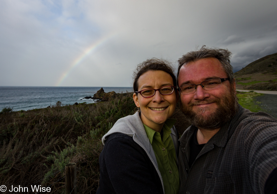 Caroline Wise and John Wise on the California coast under a rainbow