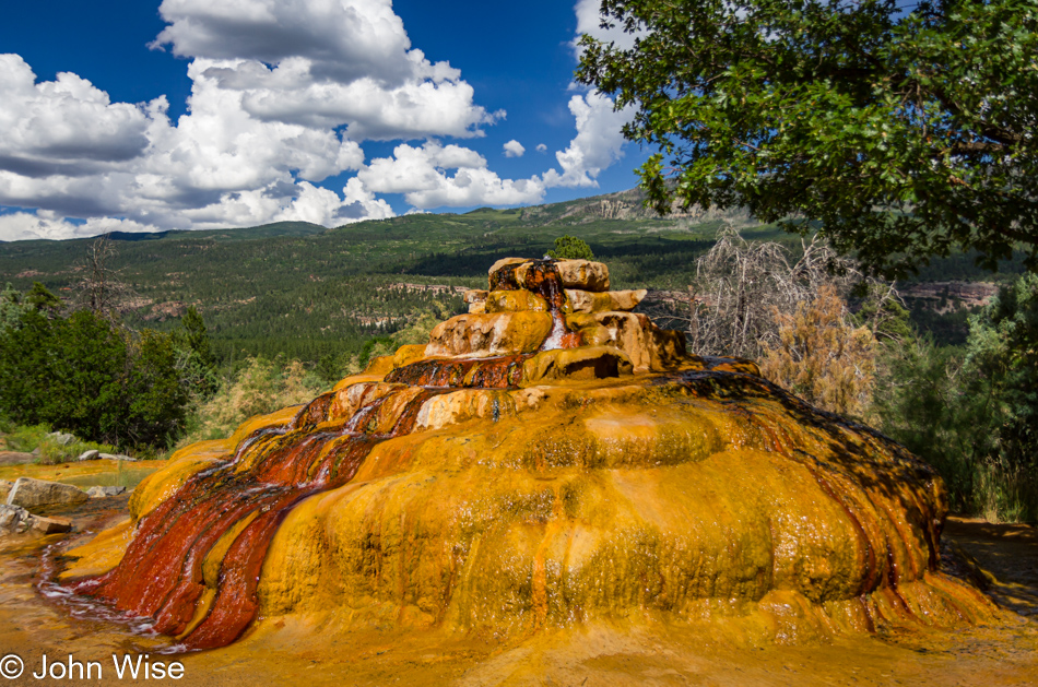 A travertine bump on the side of the road with a mysterious bubble of water coming out of the top - north of Durango, Colorado