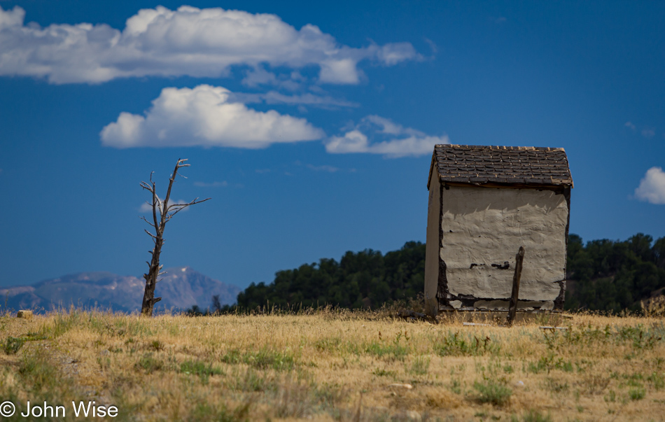 A random shack not much larger than an outhouse sits falling apart on the way to Ignacio, Colorado