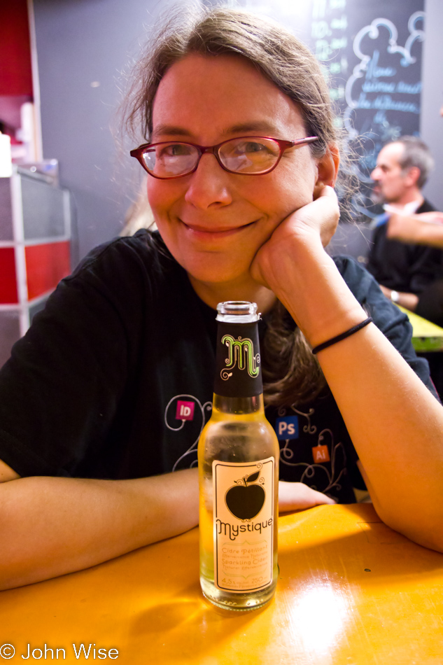 Caroline Wise at La Banquise enjoying a Mystique hard cider before digging into poutine. Montreal, Canada