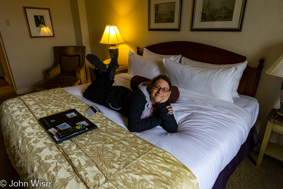 Caroline Wise inspecting our bed at Chateau Frontenac in Quebec City, Canada