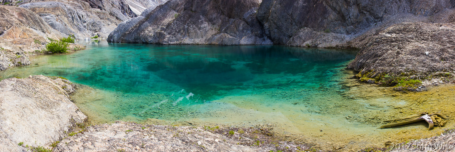 A small aquamarine pool hidden in a small cove about 30 feet (10 meters) above the Alsek River in Tatshenshini-Alsek Provincial Park British Columbia, Canada