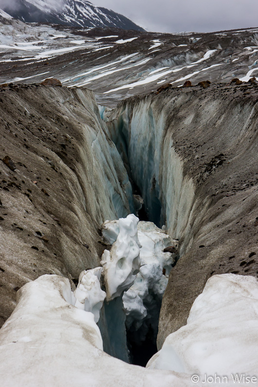 A giant deep crack in the ice where to fall in could mean certain death. On Walker Glacier off the Alsek River in Alaska