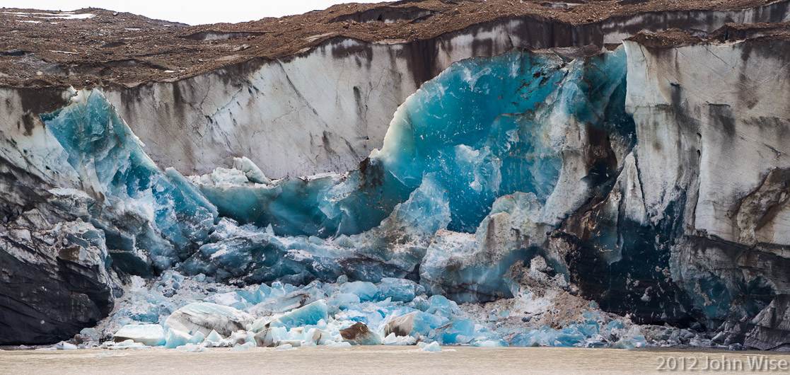 The Tweedsmuir Glacier calving a giant piece of ice into the Alsek River at Turnback Canyon in Tatshenshini-Alsek Provincial Park British Columbia, Canada