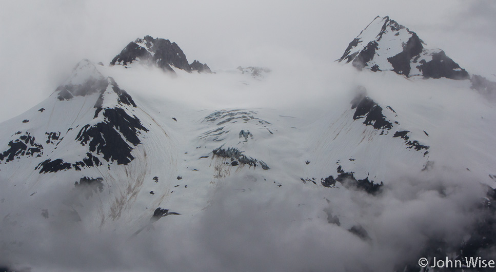 A hanging glacier can just be seen under the thick cover of snow here on the Alsek River in Alaska, United States