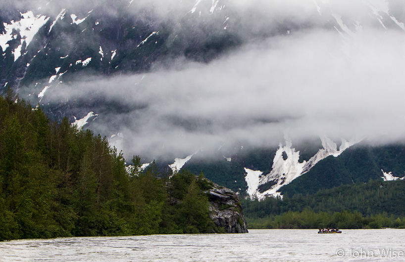 On the Alsek River with a raft ahead showing the scale of our surroundings here in Alaska