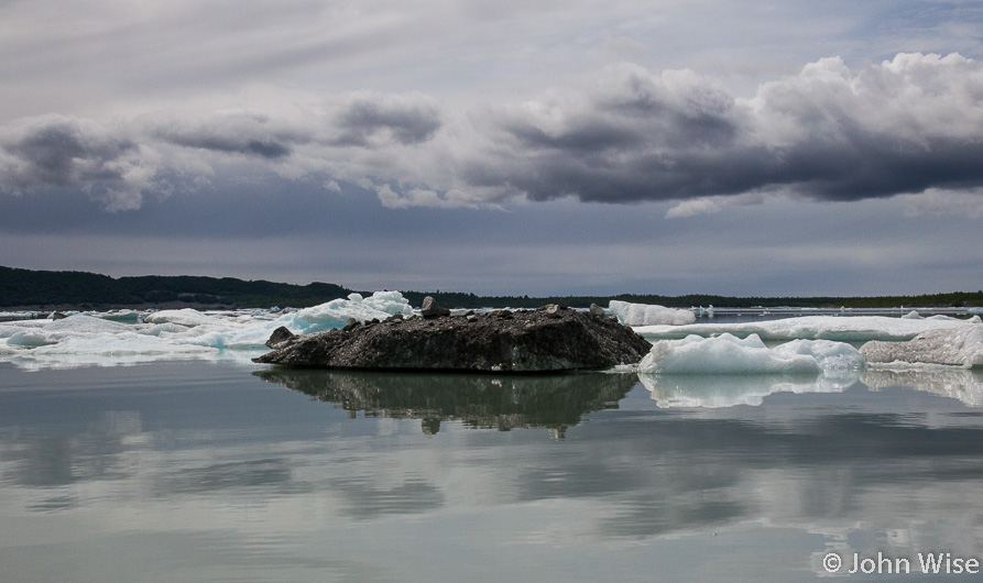 A rock and dirt covered iceberg is the black sheep of icebergs on Alsek Lake in Alaska