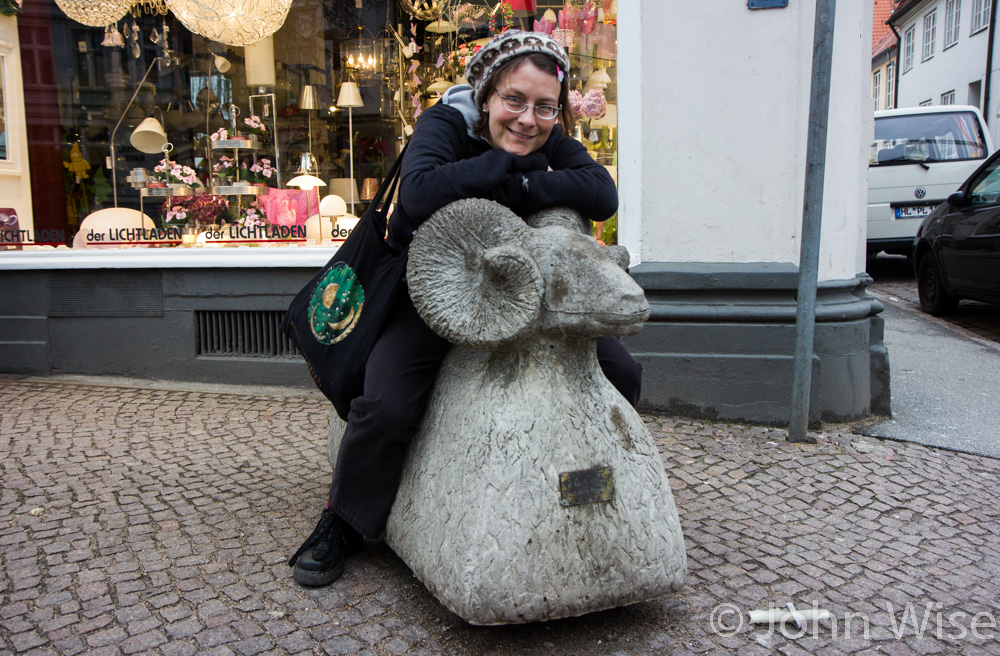 Caroline Wise in Lübeck, Germany riding a stone sheep