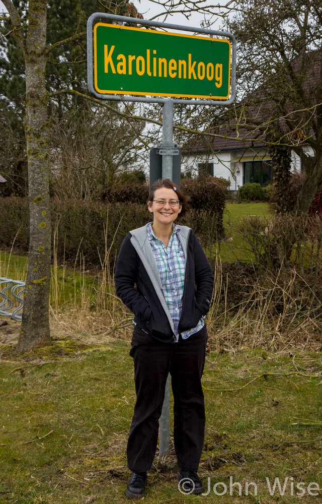 Caroline Wise standing in front of the Karolinenkoog sign in northwest Germany