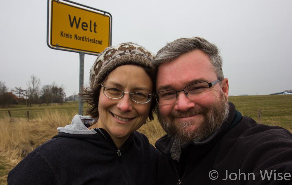 Caroline and John Wise stand before the sign announcing the World (Welt) in Germany