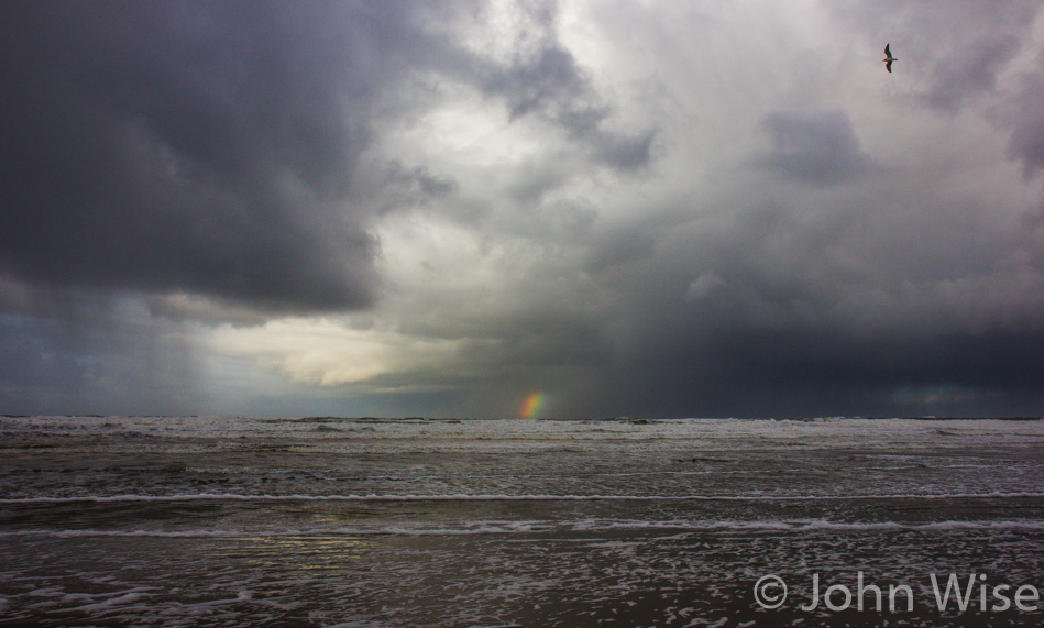 A short rainbow in the distance at South Beach State Park in Oregon