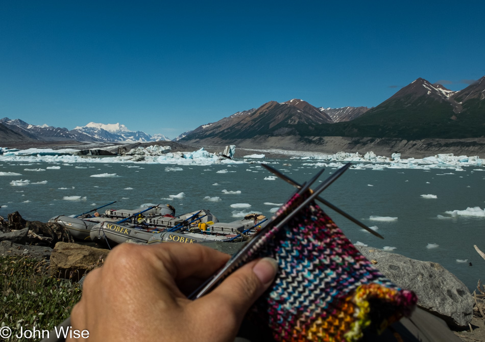 Caroline Wise knitting socks at Lowell Glacier and the lake in Kluane National Park Yukon, Canada