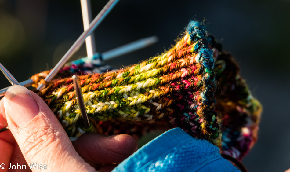Caroline Wise knitting a pair of socks for John Wise at Lowell Lake in Kluane National Park Yukon, Canada