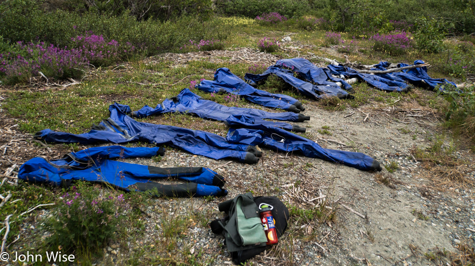 Drysuits laid out to dry following a successful run of Lava North on the Alsek River in Yukon, Canada