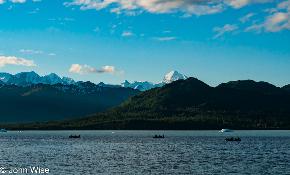 Canadian tour of boaters heading down the Alsek River in front of Mount Fairweather in Alaska
