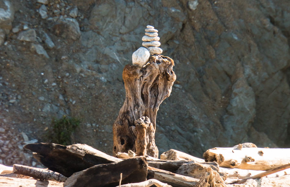 A cairn held high atop a piece of drift wood at Andrew Molera State Park