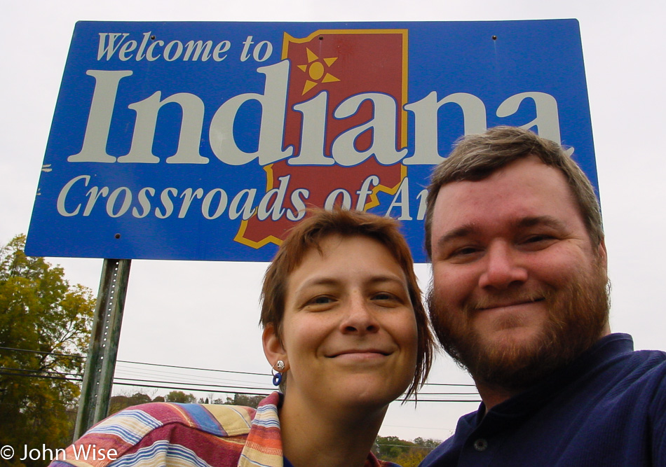 Caroline Wise and John Wise in front of the Welcome to Indiana state sign