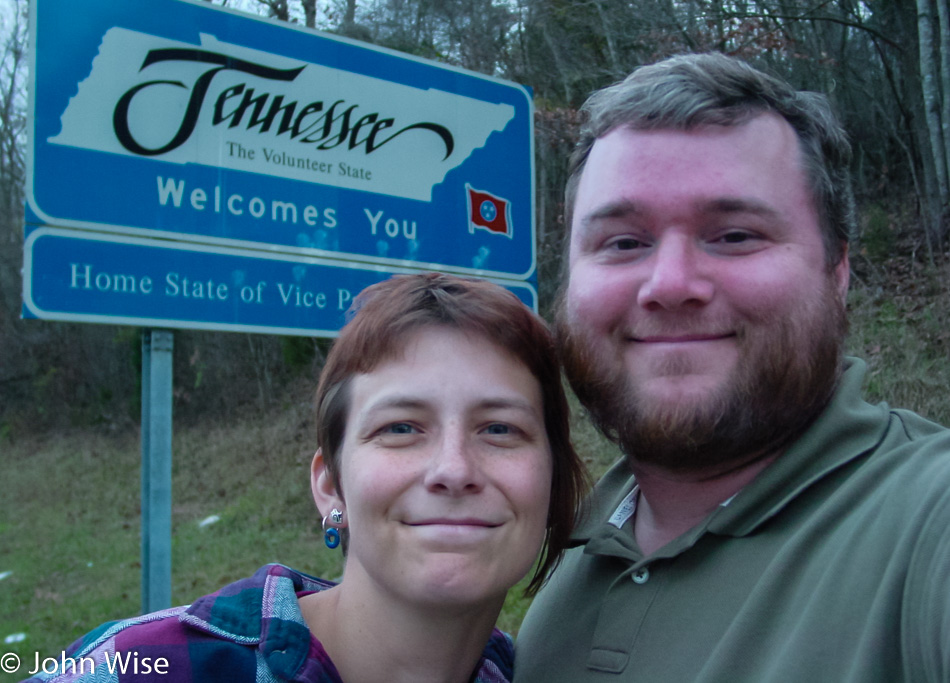 Caroline Wise and John Wise in front of the Welcome to Tennessee state sign