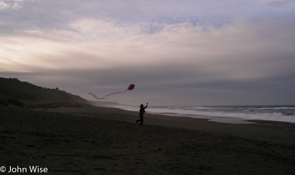 Caroline Wise flying her kite on the Oregon Coast
