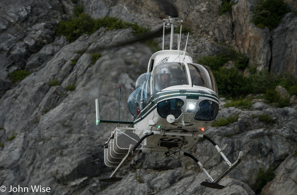 Helicopter landing in camp in front of Tweedsmuir Glacier in British Columbia, Canada
