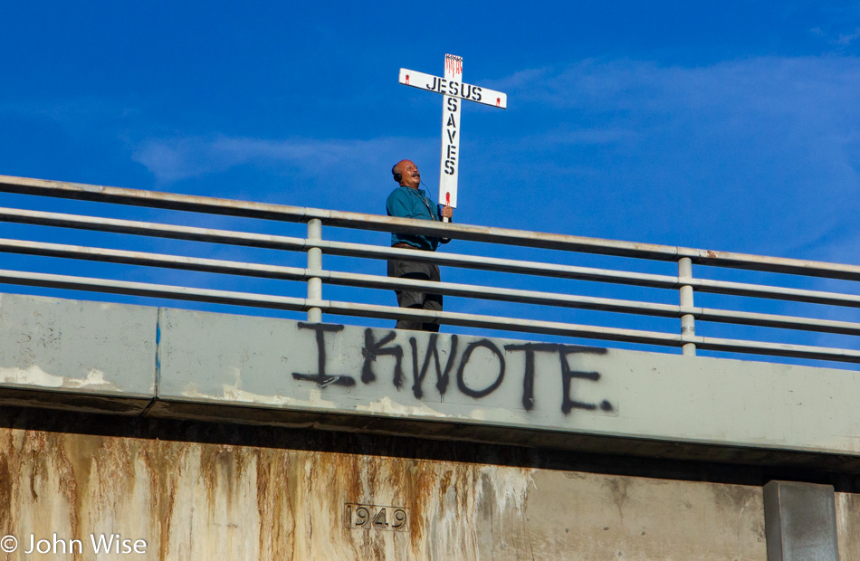 Man on freeway overpass in Los Angeles, California