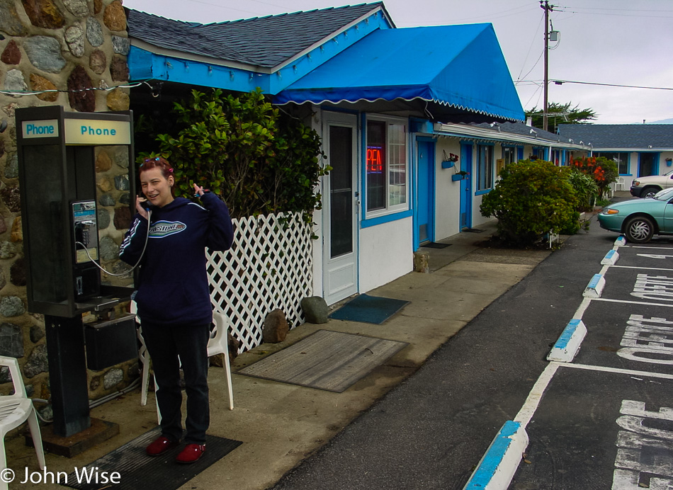 Caroline Wise on a pay phone at Piedras Blancas Motel on the Pacific Coast in California