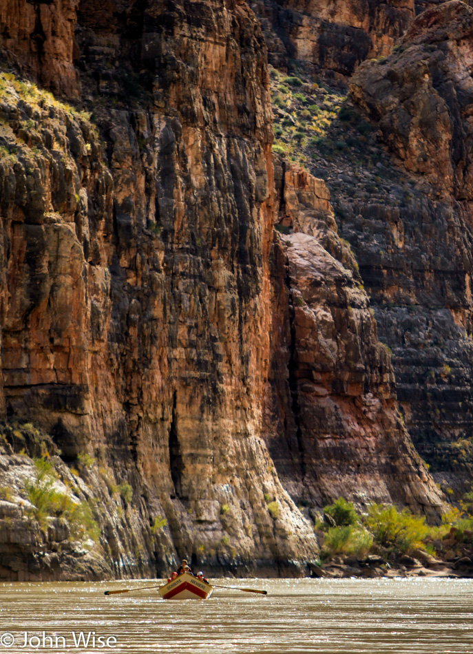 Floating down the immense Colorado River with canyon wall towering next to us