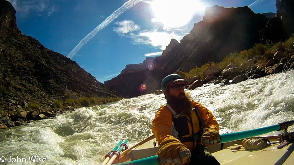 Steven Kenny rowing rapids on the Colorado River in the Grand Canyon