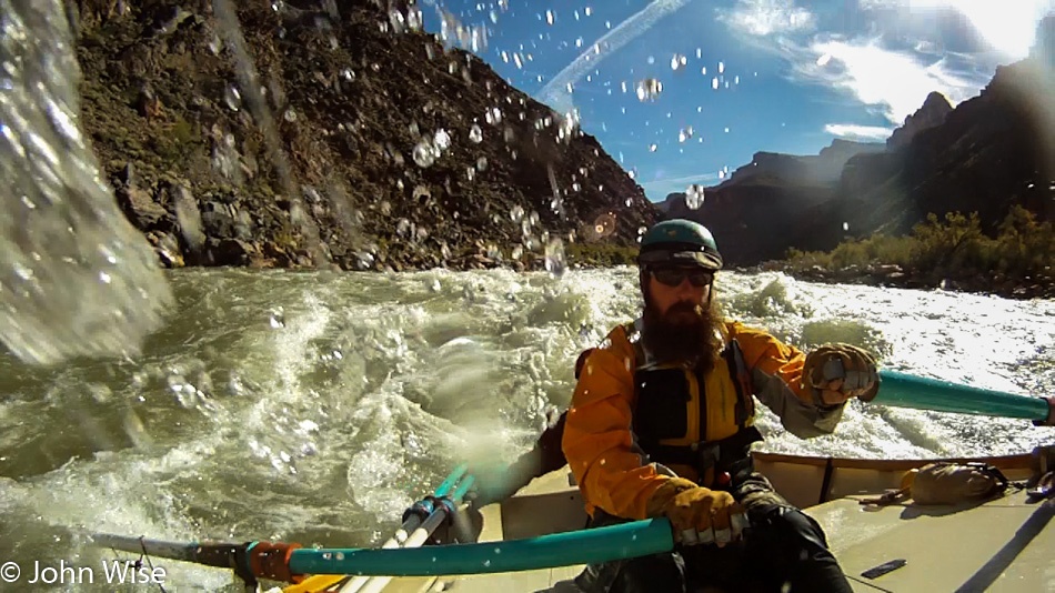 Steven Kenny rowing rapids on the Colorado River in the Grand Canyon