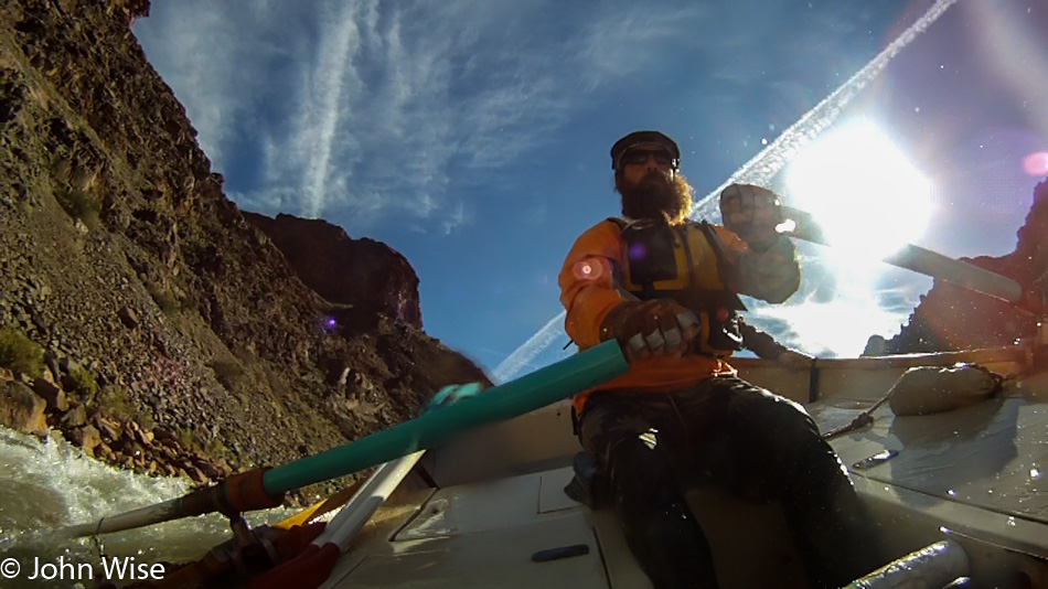 Steven Kenny rowing rapids on the Colorado River in the Grand Canyon