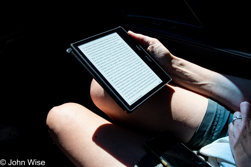 Caroline Wise reading from a Kindle in Phoenix, Arizona